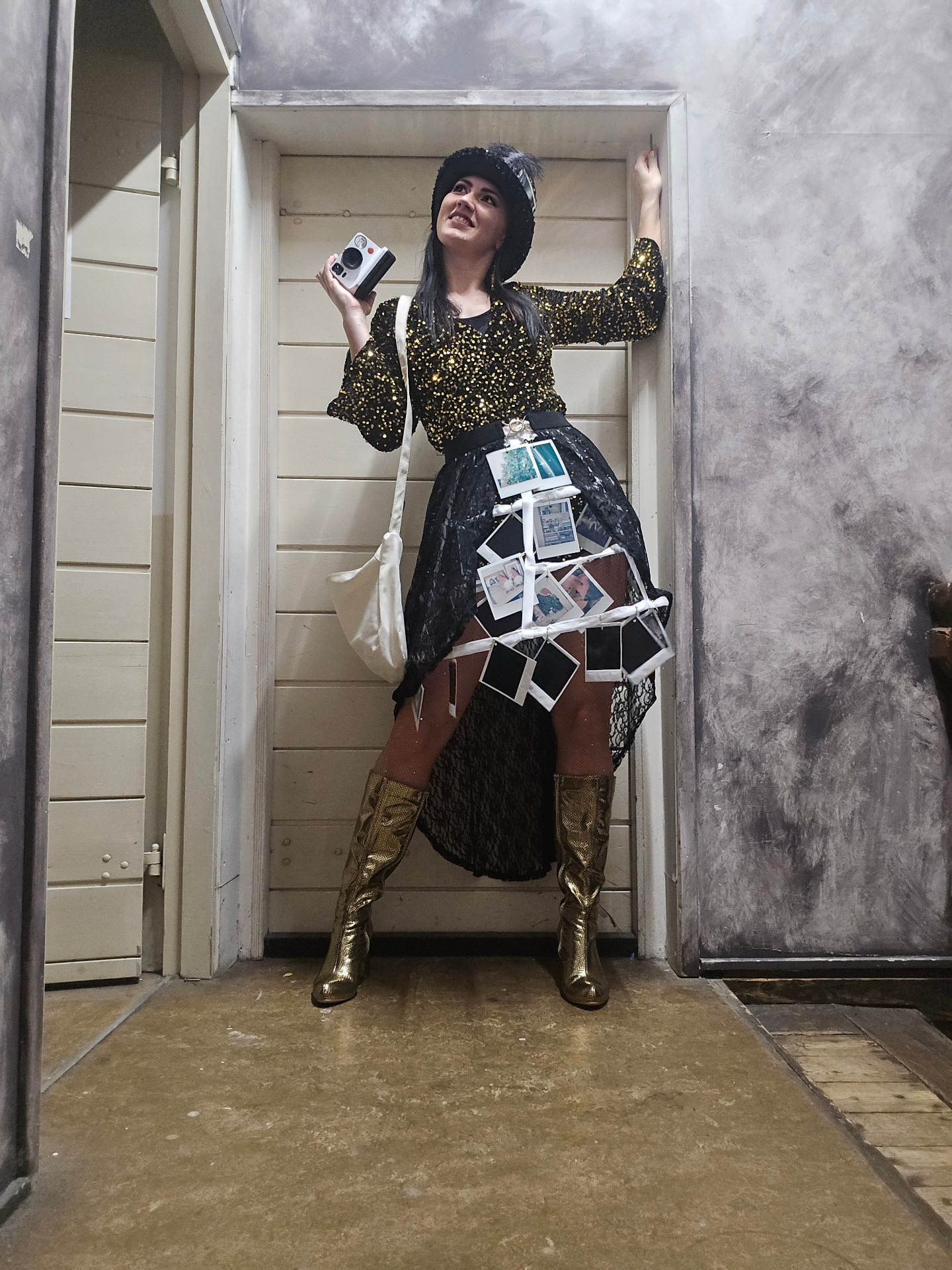 Polaroid Lady in gouden glitteroutfit met instantcamera backstage